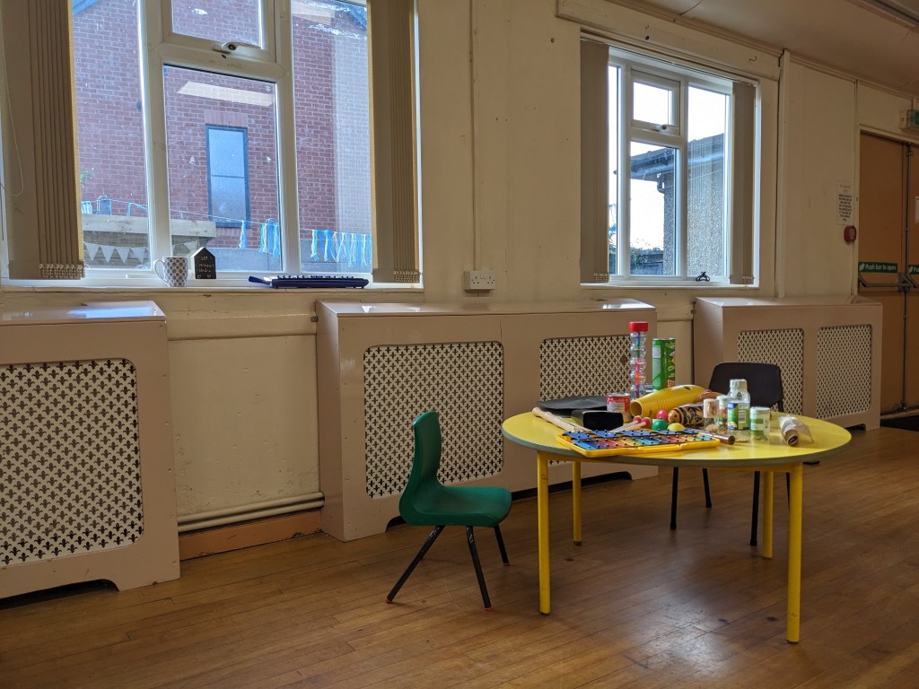 Photo of musical instruments in a community centre on a low table
